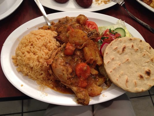 Bowl of sopa de gallina, a traditional Salvadoran chicken soup, served with rice